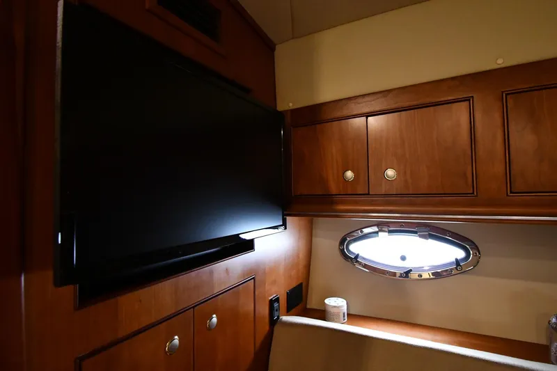 Slide: The Image of 2007 Cruisers Yachts 455 Express Motoryacht interior with TV and porthole window. - 37