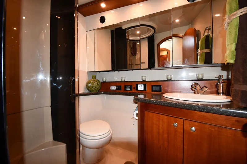 Slide: The Image of Luxurious bathroom in 2007 Cruisers Yachts 455 Express Motoryacht with elegant fixtures and wood cabinetry. - 40