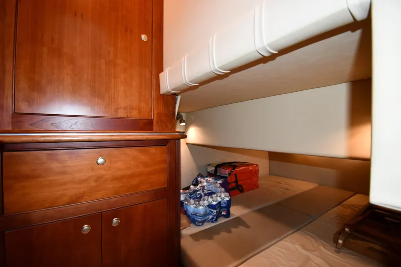 Slide: The Image of 2007 Cruisers Yachts 455 Express Motoryacht cabin with wooden cabinetry and storage space. - 42