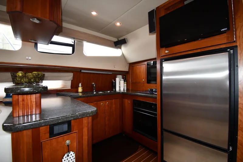 Slide: The Image of Luxurious kitchen interior of 2007 Cruisers Yachts 455 Express Motoryacht with modern appliances. - 48