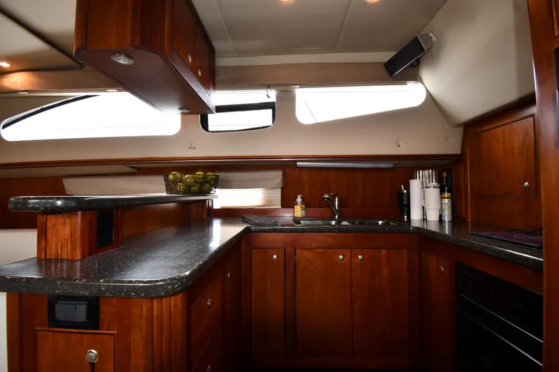 Slide: The Image of Luxurious kitchen interior of 2007 Cruisers Yachts 455 Express Motoryacht with wood cabinetry. - 49