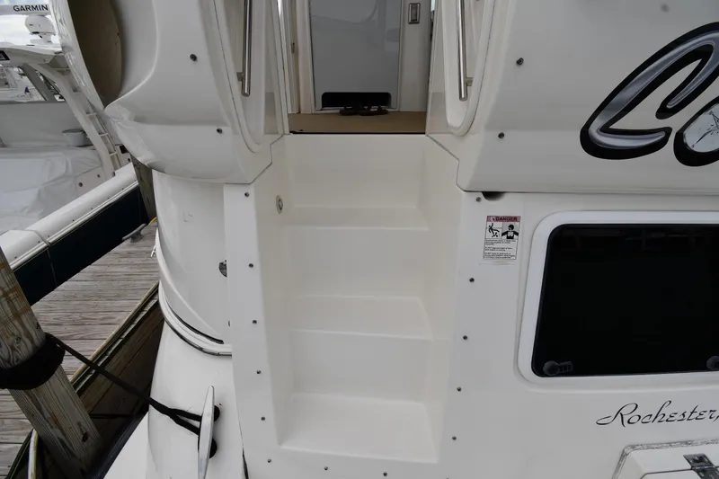 Slide: The Image of 2007 Cruisers Yachts 455 Express Motoryacht stern view with steps and dock. - 5