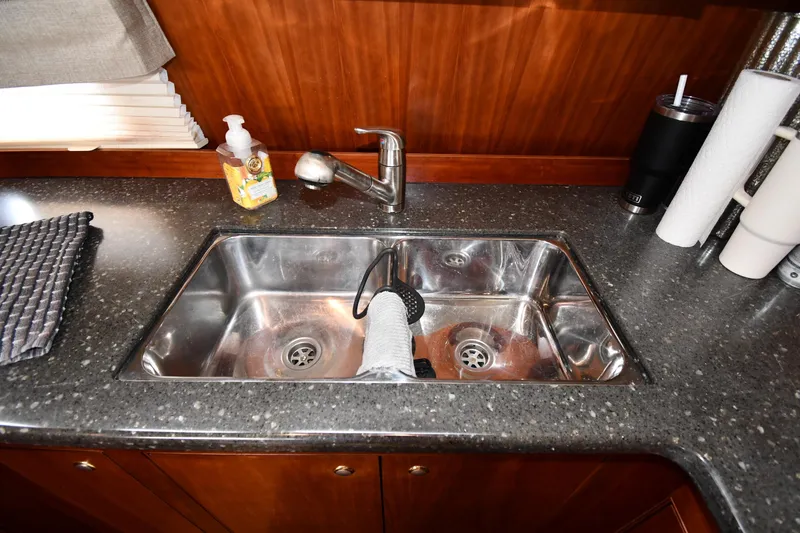 Slide: The Image of 2007 Cruisers Yachts 455 Express Motoryacht kitchen sink with faucet and countertop accessories. - 50