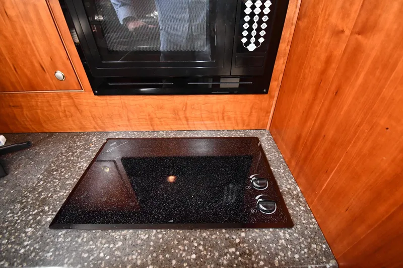 Slide: The Image of 2007 Cruisers Yachts 455 Express Motoryacht kitchen with stovetop and microwave. - 52