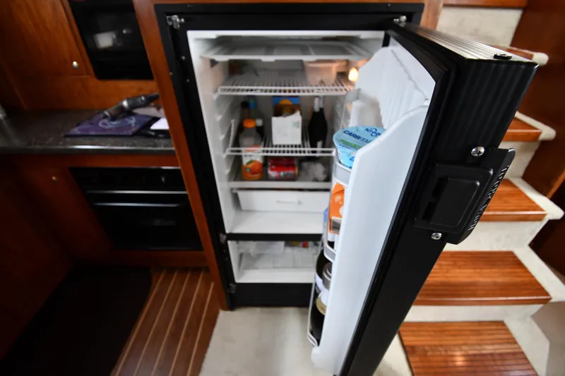 Slide: The Image of Open refrigerator in 2007 Cruisers Yachts 455 Express Motoryacht kitchen interior. - 53
