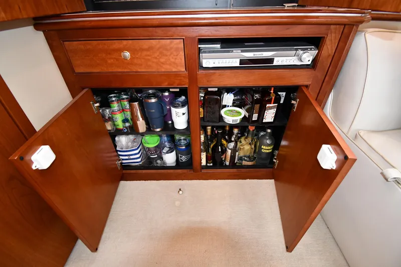 Slide: The Image of 2007 Cruisers Yachts 455 Express Motoryacht interior cabinet with beverages and audio equipment. - 55