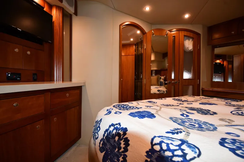 Slide: The Image of Luxurious 2007 Cruisers Yachts 455 Express Motoryacht bedroom with elegant wood cabinetry. - 59