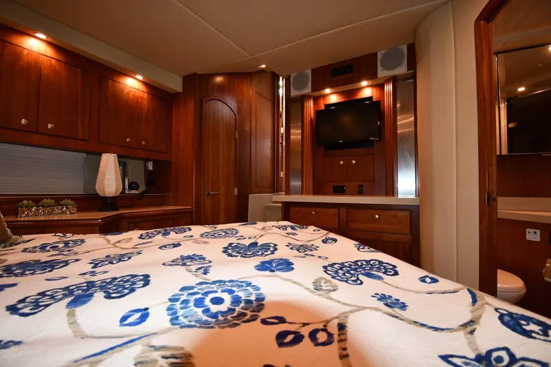 Slide: The Image of Luxurious 2007 Cruisers Yachts 455 Express Motoryacht bedroom with elegant wood cabinetry. - 60