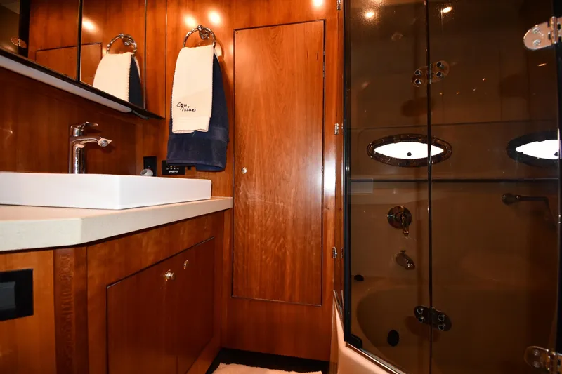 Slide: The Image of Luxurious bathroom in 2007 Cruisers Yachts 455 Express Motoryacht with wood cabinetry and modern fixtures. - 64