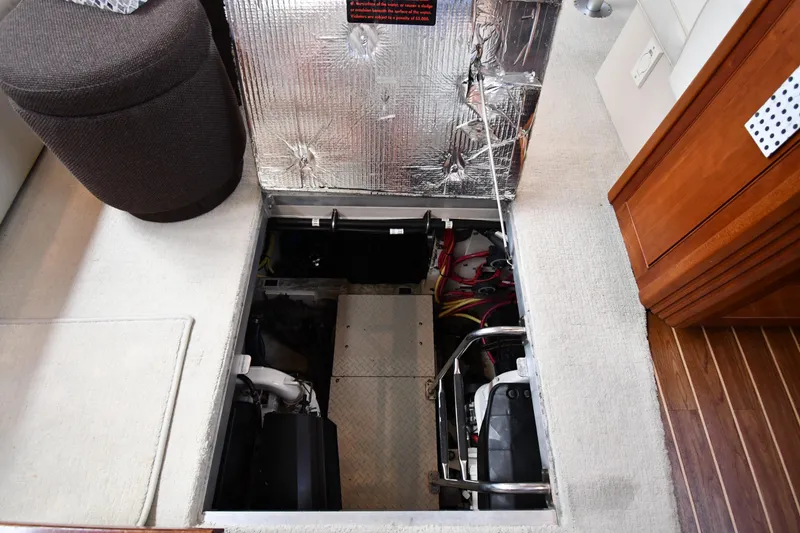 Slide: The Image of 2007 Cruisers Yachts 455 Express Motoryacht engine compartment with open hatch and visible wiring. - 65