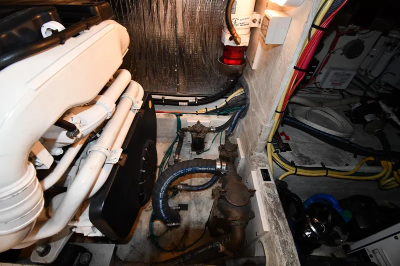 Slide: The Image of Engine room of 2007 Cruisers Yachts 455 Express Motoryacht with visible pipes and wiring. - 70