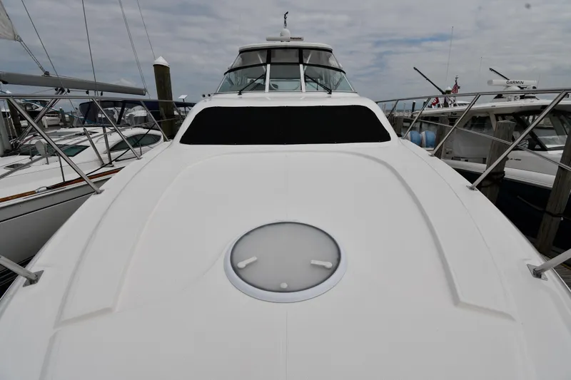 Slide: The Image of 2007 Cruisers Yachts 455 Express Motoryacht docked, showcasing sleek design and spacious deck. - 8