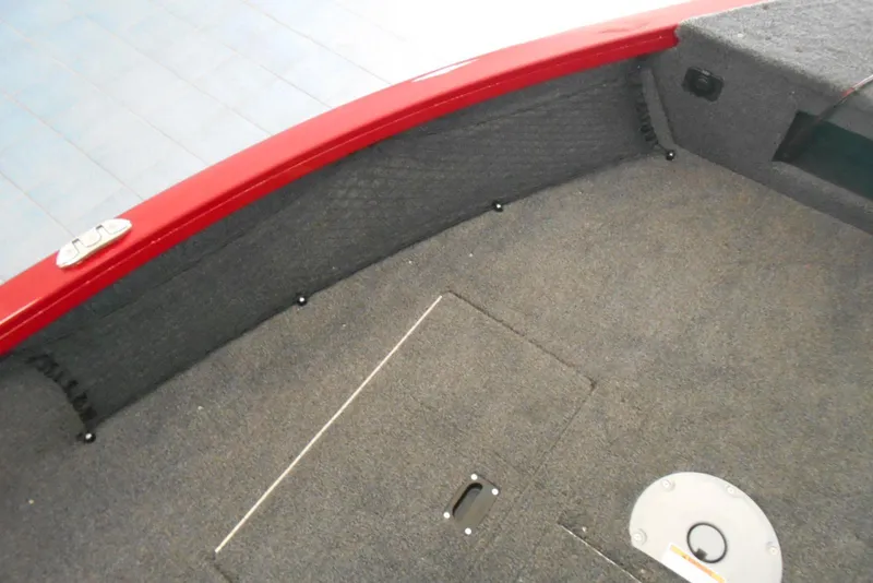 Slide: The Image of 2025 Crestliner 1650 Fish Hawk SC JS boat interior with carpeted deck and storage hatch. - 10