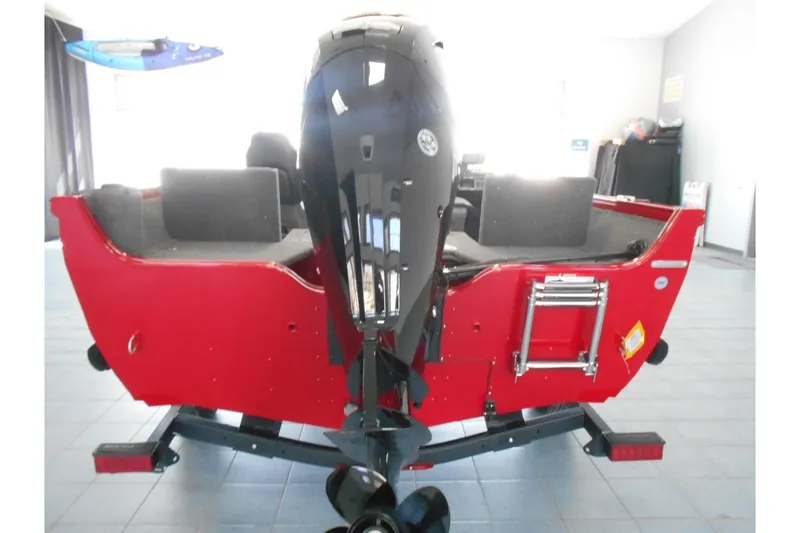 Slide: The Image of 2025 Crestliner 1650 Fish Hawk SC JS boat, red exterior, rear view with motor. - 5