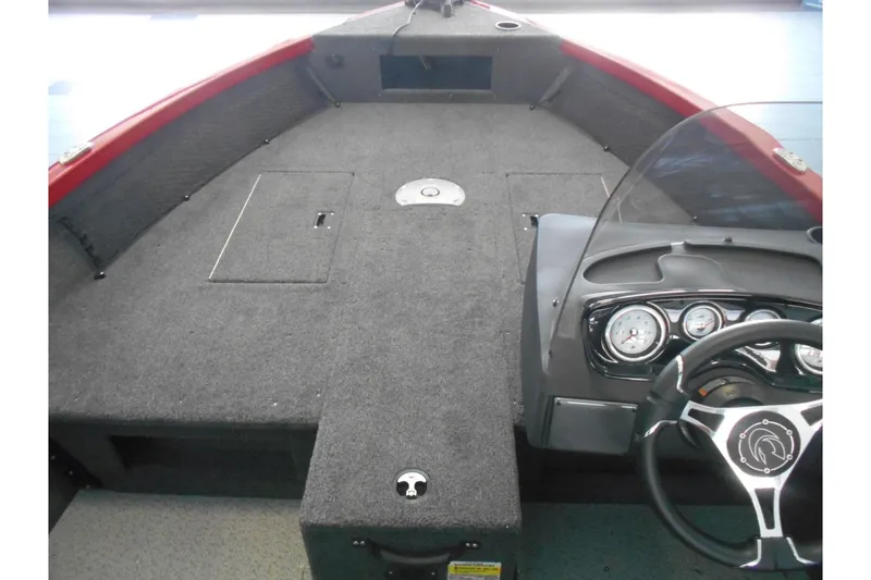 Slide: The Image of 2025 Crestliner 1650 Fish Hawk SC JS boat interior with steering console and carpeted deck. - 6