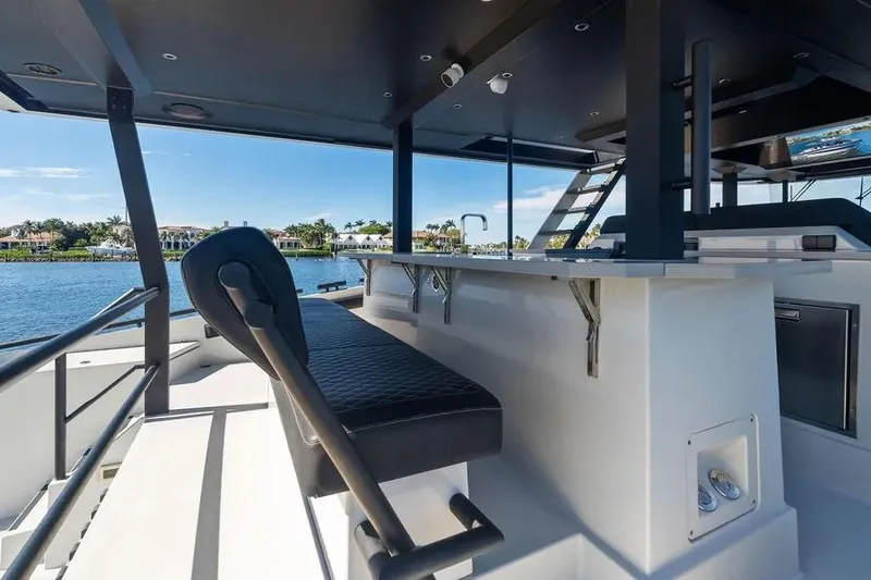 Slide: The Image of Luxurious 2019 DutchCraft 56 Open yacht interior with sleek seating and waterfront view. - 12
