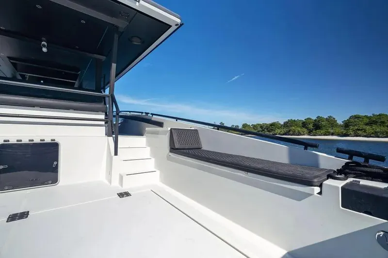 Slide: The Image of 2019 DutchCraft 56 Open yacht deck with seating, under clear blue sky. - 9