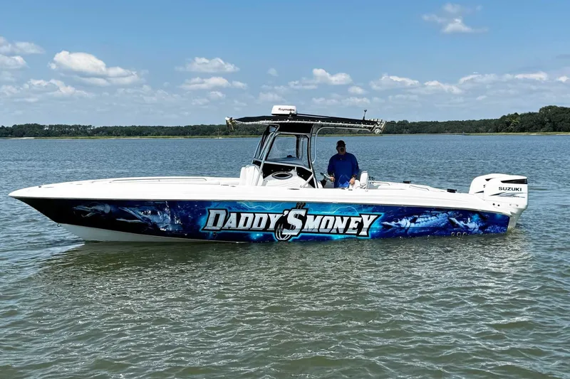 The Image of 2005 Wellcraft 32 CCF boat on water, featuring "Daddy's Money" graphic design. - 1