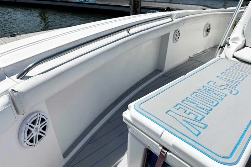 Slide: The Image of 2005 Wellcraft 32 CCF boat interior with cushioned seating and speaker detail. - 14