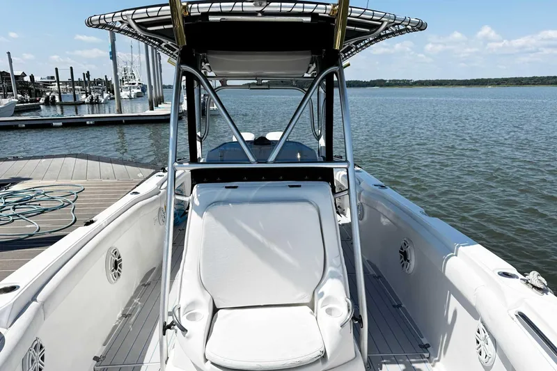 Slide: The Image of 2005 Wellcraft 32 CCF boat docked by the water, showcasing seating and console. - 15
