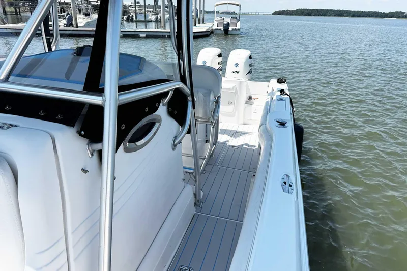 Slide: The Image of 2005 Wellcraft 32 CCF boat with dual Suzuki engines docked on calm water. - 16