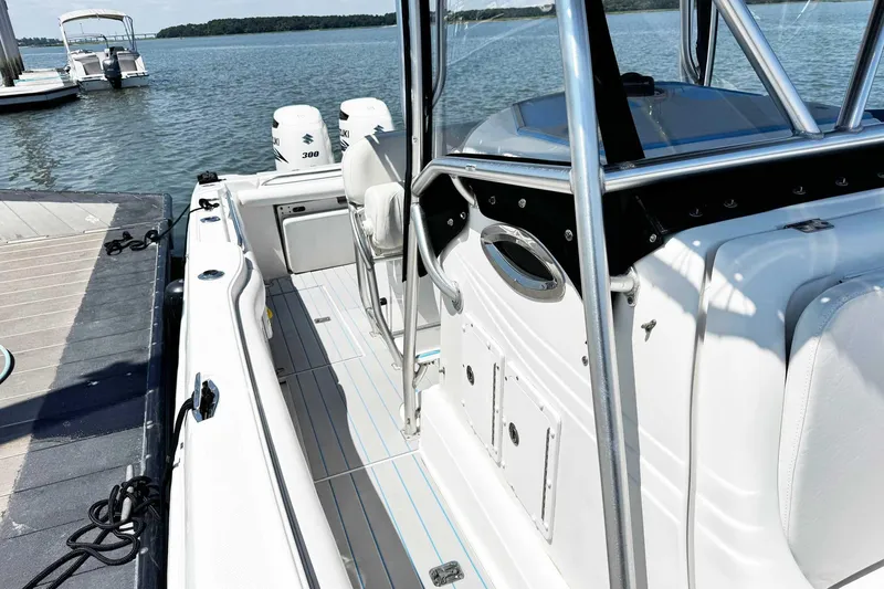 Slide: The Image of 2005 Wellcraft 32 CCF boat docked, featuring dual Suzuki 300 engines. - 17