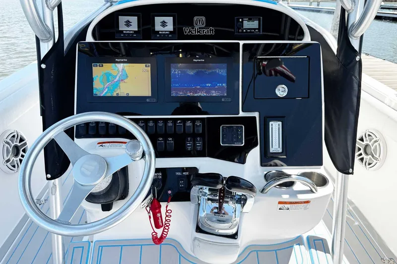 Slide: The Image of Dashboard of a 2005 Wellcraft 32 CCF boat with navigation screens and controls. - 26