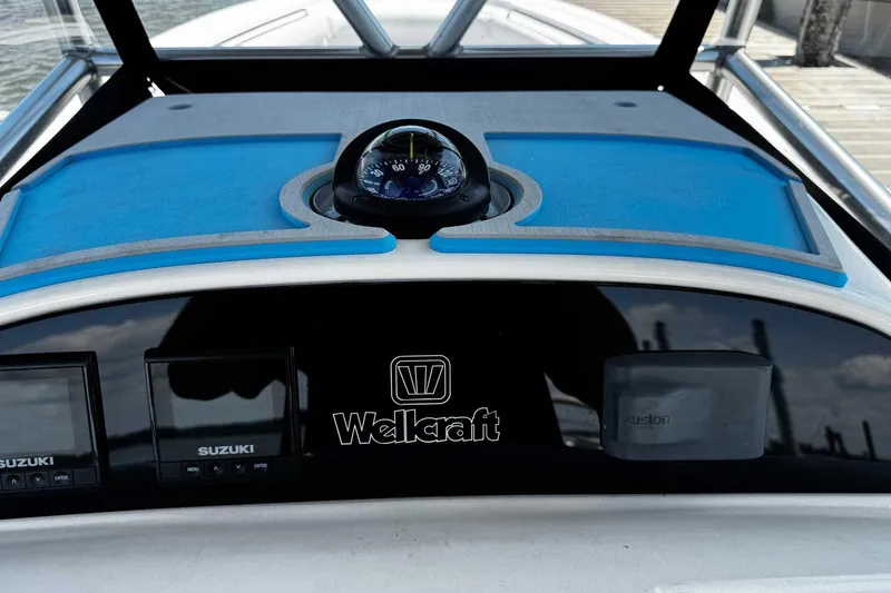 Slide: The Image of Dashboard of 2005 Wellcraft 32 CCF boat with compass and Suzuki displays. - 27