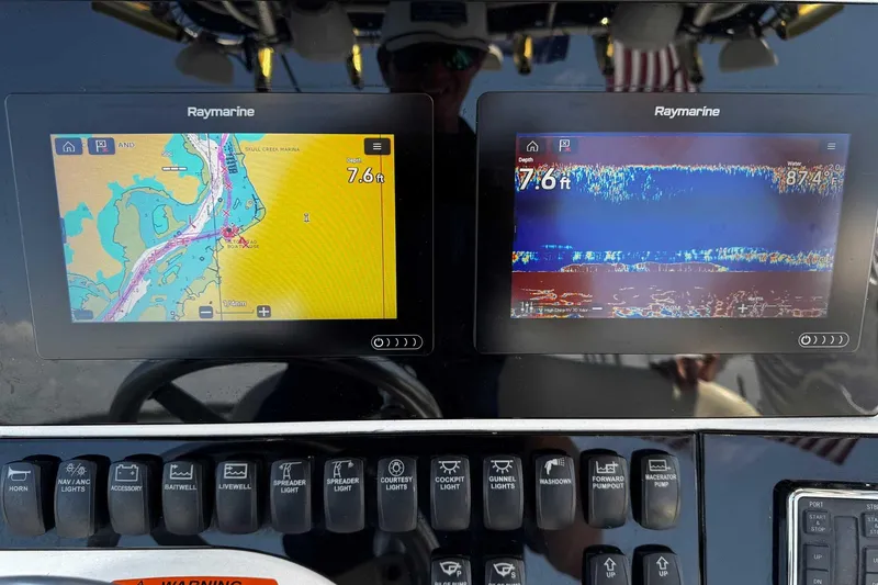 Slide: The Image of Dashboard of a 2005 Wellcraft 32 CCF with Raymarine navigation displays. - 28