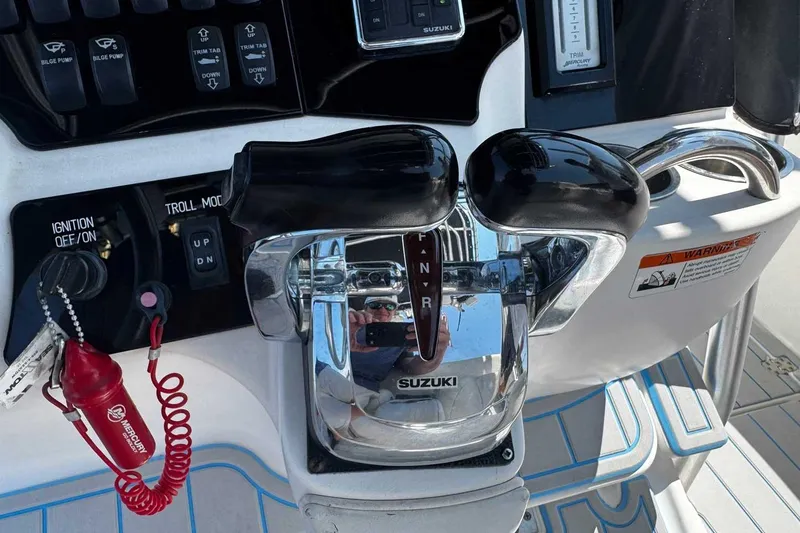 Slide: The Image of Control panel of a 2005 Wellcraft 32 CCF boat with Suzuki throttle controls. - 29