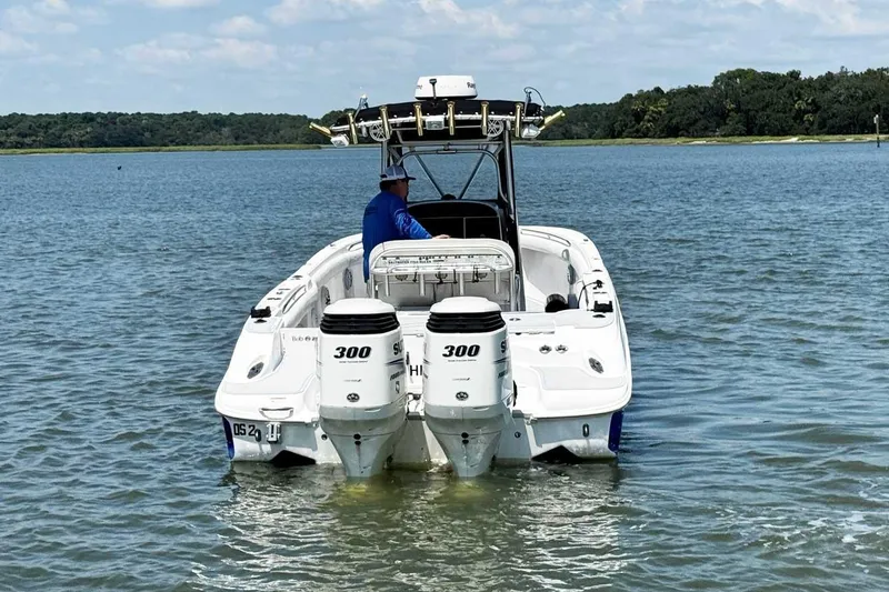 Slide: The Image of 2005 Wellcraft 32 CCF boat with dual 300 HP engines on calm water. - 3