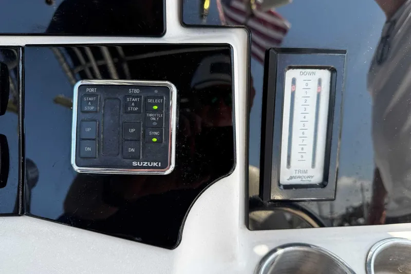 Slide: The Image of Control panel of a 2005 Wellcraft 32 CCF boat with Suzuki and Mercury trim indicators. - 30