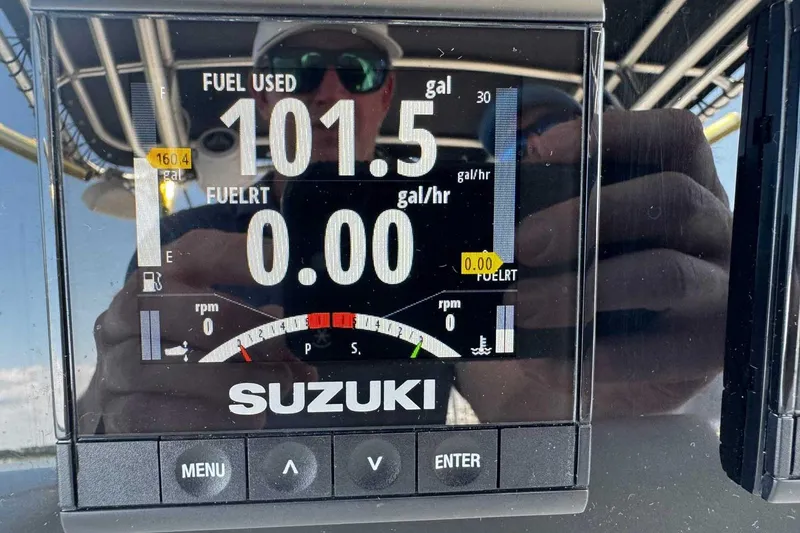 Slide: The Image of Close-up of Suzuki boat fuel gauge showing 101.5 gallons used, 2005 Wellcraft 32 CCF. - 34