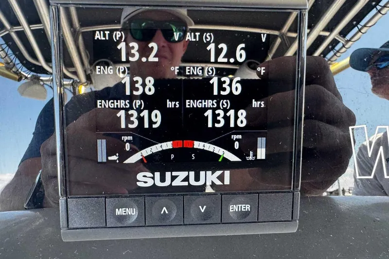 Slide: The Image of Close-up of a Suzuki engine display on a 2005 Wellcraft 32 CCF boat. - 35