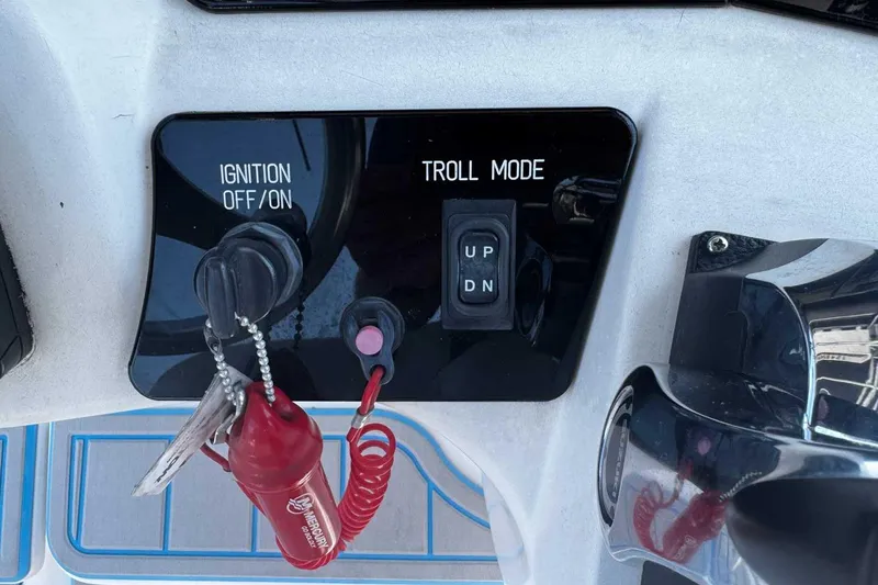Slide: The Image of Control panel of a 2005 Wellcraft 32 CCF boat with ignition and troll mode. - 38