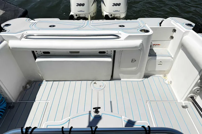 Slide: The Image of 2005 Wellcraft 32 CCF boat deck with twin 300 horsepower engines, featuring sleek white design. - 41