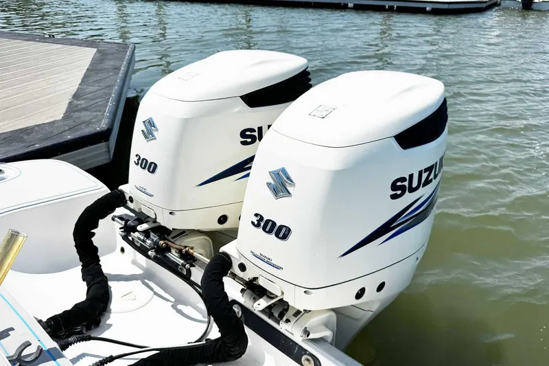 Slide: The Image of Twin Suzuki 300 outboard engines on a 2005 Wellcraft 32 CCF boat at the dock. - 45