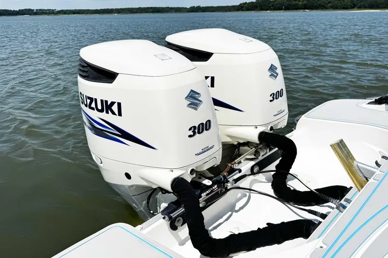 Slide: The Image of Twin Suzuki 300 outboard engines on a 2005 Wellcraft 32 CCF boat in open water. - 46