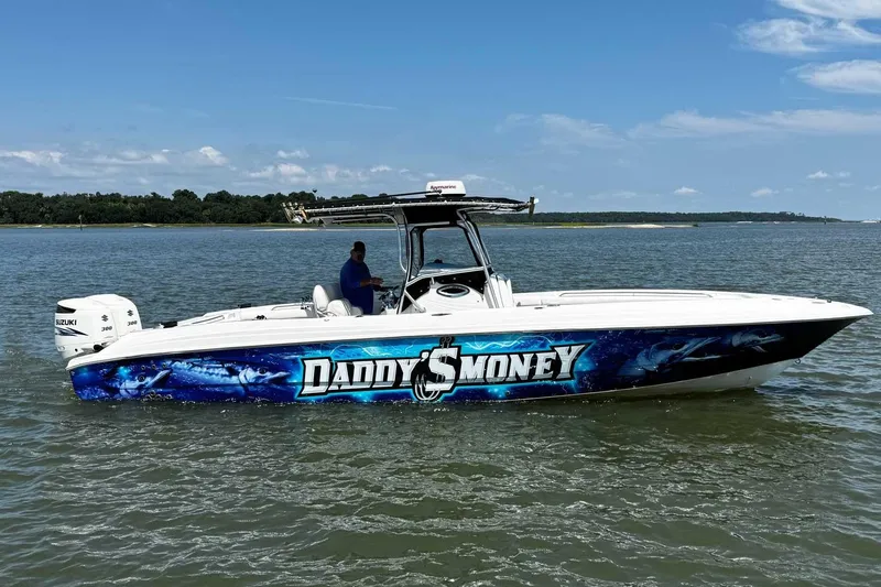 Slide: The Image of 2005 Wellcraft 32 CCF boat with "Daddy's Money" graphics on the water. - 5