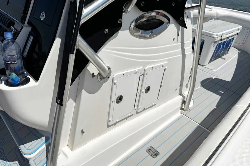Slide: The Image of 2005 Wellcraft 32 CCF boat deck with storage compartments and a cooler. - 52