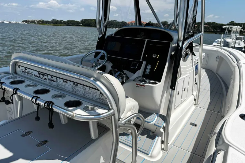 Slide: The Image of 2005 Wellcraft 32 CCF boat interior with steering console and fishing rod holders. - 55