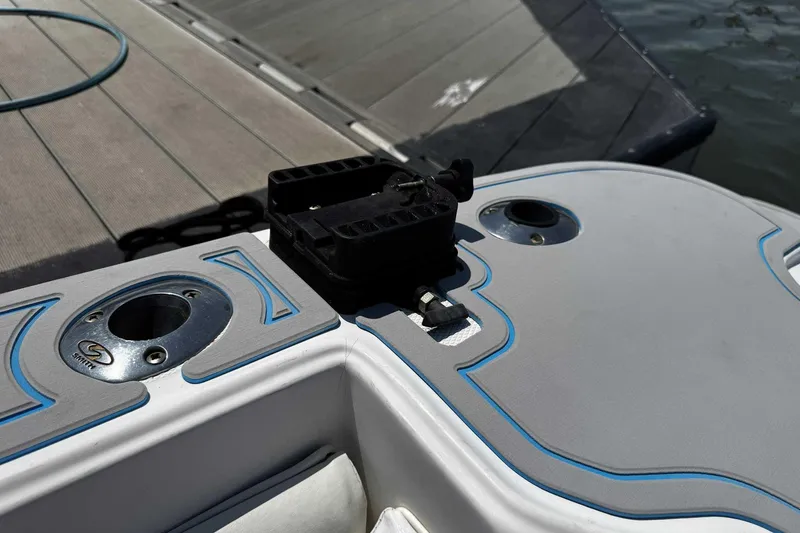 Slide: The Image of 2005 Wellcraft 32 CCF boat deck with rod holders and dock in background. - 57