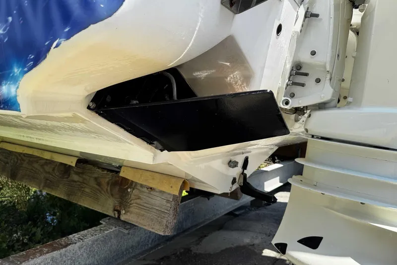 Slide: The Image of 2005 Wellcraft 32 CCF boat hull and motor detail on a trailer. - 58