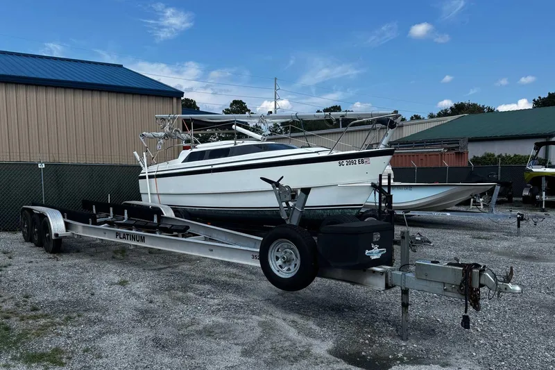 Slide: The Image of 2005 Wellcraft 32 CCF boat on trailer, parked outdoors near storage buildings. - 59