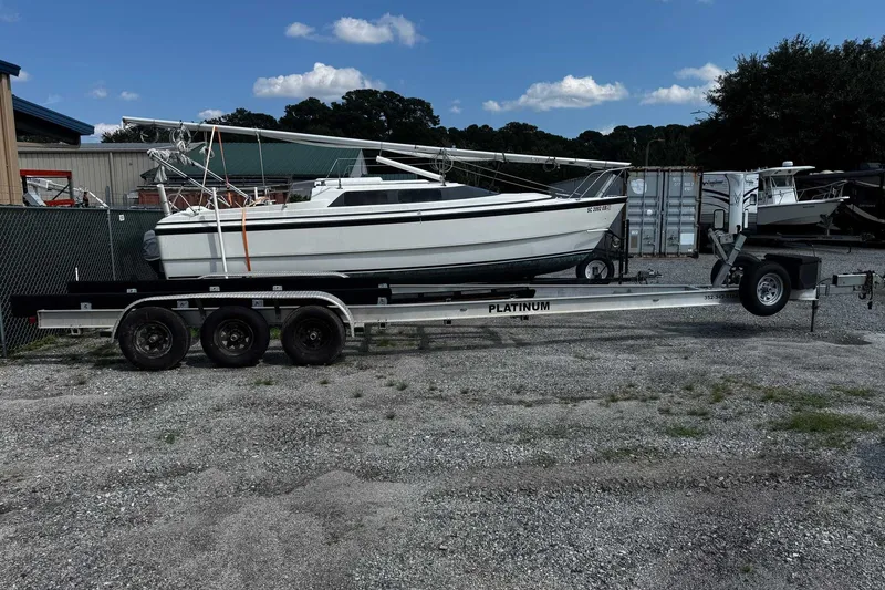 Slide: The Image of 2005 Wellcraft 32 CCF boat on a trailer in a storage yard. - 60
