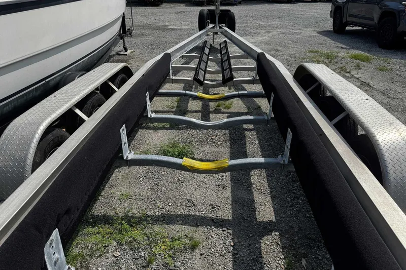 Slide: The Image of Trailer for 2005 Wellcraft 32 CCF boat on gravel lot. - 62