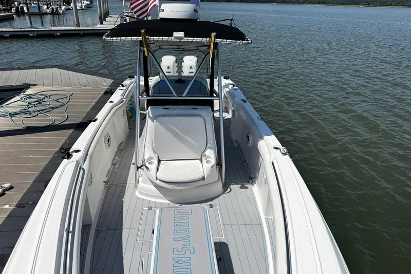 Slide: The Image of 2005 Wellcraft 32 CCF boat docked, featuring spacious deck and twin engines. - 9