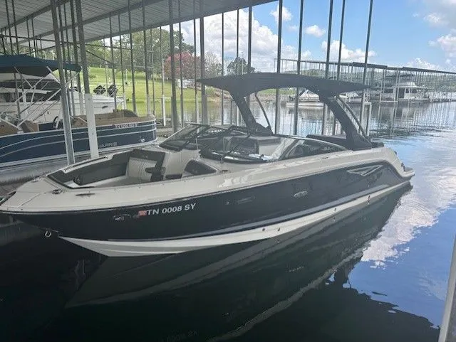 The Image of 2017 Sea Ray SLX 280 boat docked in a marina under a covered area. - 0