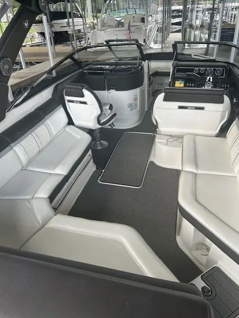 Slide: The Image of Interior of 2017 Sea Ray SLX 280 boat with white seating and modern dashboard. - 2