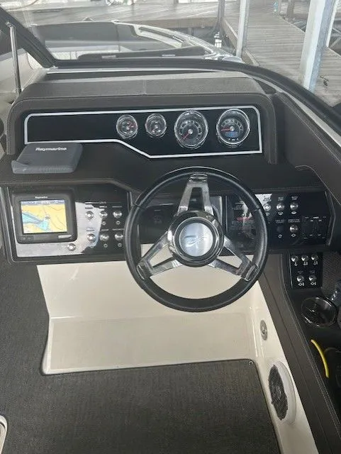 Slide: The Image of 2017 Sea Ray SLX 280 dashboard with steering wheel and navigation system. - 3